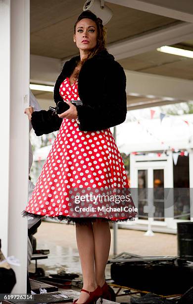 Stylish young lady standing standing on the PIt Wall wearing a red and white polka dot dress at Goodwood on September 10, 2016 in Chichester, England.