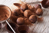 chocolate truffles sprinkled with cocoa powder close-up