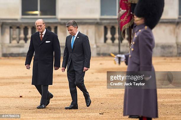 Colombian President Juan Manuel Santos and Prince Philip, Duke of Edinburgh walk back to the royal pavilion after inspecting the guard of honour...