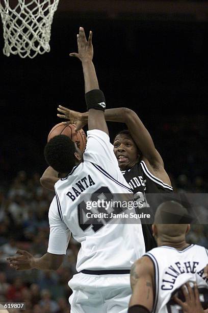 Marcus Douthit of Providence shoots over Marcus Banta of Penn State during the NCAA South Region First Round Game at the Lousiana Superdome in New...