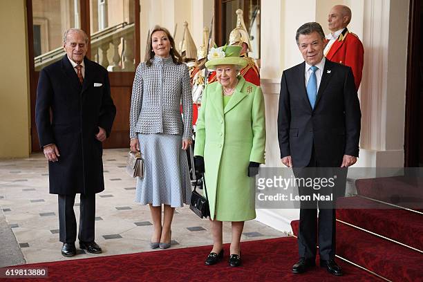 Prince Philip, Duke of Edinburgh and Queen Elizabeth II pose for a group photograph with Colombia's President Juan Manuel Santos and his wife Maria...