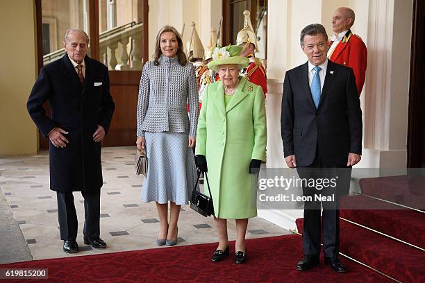 Prince Philip, Duke of Edinburgh and Queen Elizabeth II pose for a group photograph with Colombia's President Juan Manuel Santos and his wife Maria...