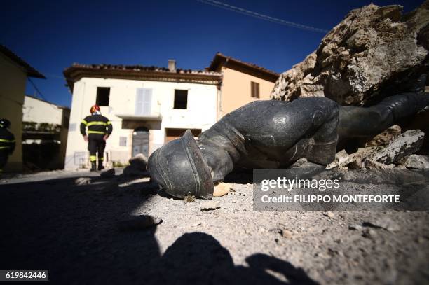 The statue of a memorial lies on the ground in the village of San Pellegrino near Norcia, on November 1 two days after a 6.5 magnitude earthquake hit...