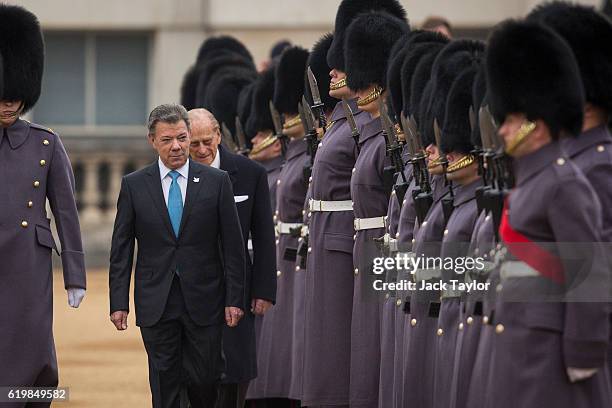 Colombian President Juan Manuel Santos and Prince Philip, Duke of Edinburgh inspect the guards of honour during the Official Ceremonial Welcome for...