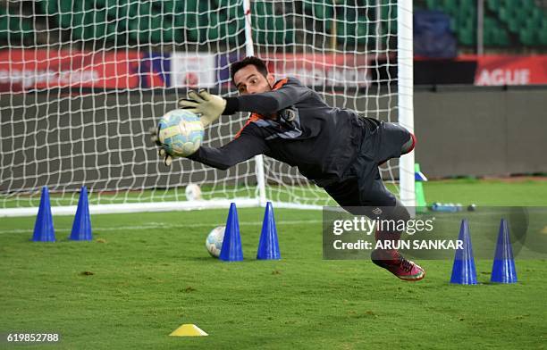 Mumbai City FC's goalkeeper Roberto Volpato Netto makes a save as he takes part in a practice session ahead of the Indian Super League football match...