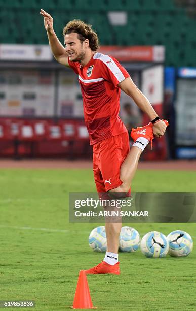 Mumbai City FC's forward Diego Forlán stretches as he takes part in a practice session ahead of the Indian Super League football match between...