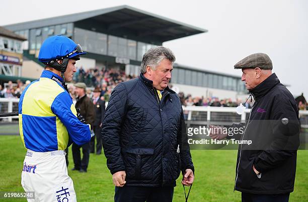 Trainer Paul Nicholls chats to Jockey Nick Scholfield and connections at Exeter Racecourse on November 1, 2016 in Exeter, England.