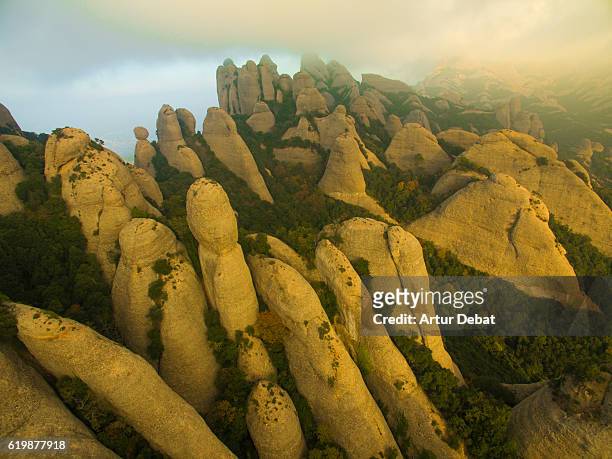 aerial picture taking with drone of the beautiful and unique montserrat mountains a tall crags with characteristic shape in the catalonia region with nice sunset light. - conglomerate fotografías e imágenes de stock