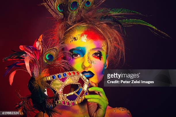 rainbow woman with a colorful venetian mask - venezianische karnevalsmaske stock-fotos und bilder