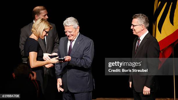Federal President Joachim Gauck and German Minister of the Interior Thomas de Maiziere awards Saskia Bartusiak of the german woman's football...