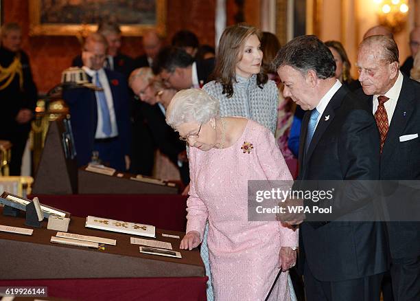 Queen Elizabeth II, Colombia's president Juan Manuel Santos with his wife, Maria Clemencia Rodriguez de Santos and Prince Philip, Duke of Edinburgh...