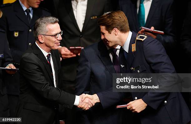 German Minister of the Interior Thomas de Maiziere awards rower Richard Schmidt the Silbernes Lorbeerblatt during the Silbernes Lorbeerblatt Award...
