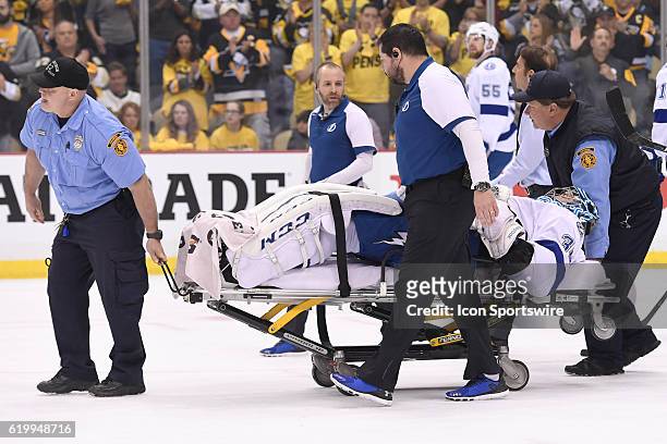 Tampa Bay Lightning goalie Ben Bishop leaves the ice on a stretcher after suffering an apparent injury during the first period of Game One in the...