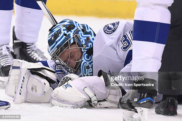 Tampa Bay Lightning goalie Ben Bishop grimaces after an apparent injury during the first period of Game One in the Eastern Conference Finals of the...