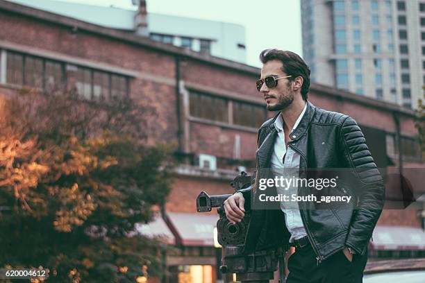 male model in the city - leather jacket stockfoto's en -beelden