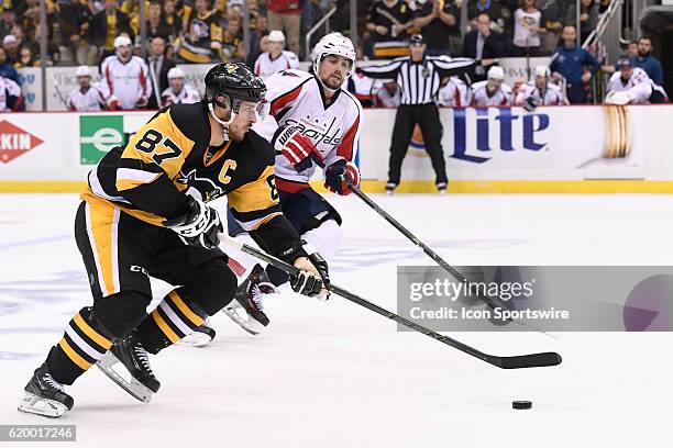 Pittsburgh Penguins center Sidney Crosby brings the puck in to the zone as Washington Capitals defenseman Matt Niskanen defends during the third...