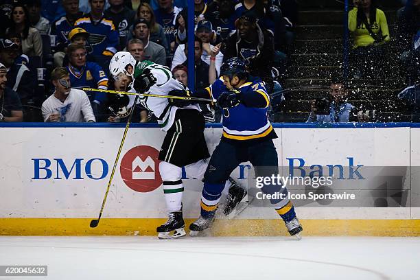 St. Louis Blues right wing Ryan Reaves hits Dallas Stars center Vernon Fiddler hard into the boards during the first period of a NHL Western...