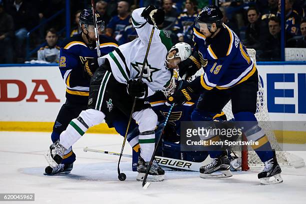 Dallas Stars left wing Antoine Roussel fights for the puck while being pressured by St. Louis Blues defenseman Jay Bouwmeester during the second...
