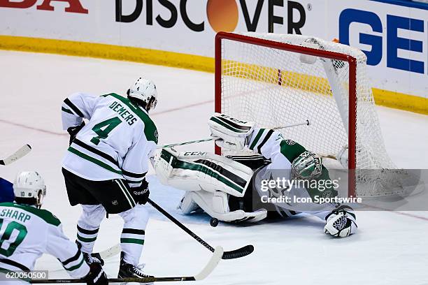 Dallas Stars goalie Kari Lehtonen makes a save and is knocked to the ice on a shot by St. Louis Blues right wing Vladimir Tarasenko during the third...