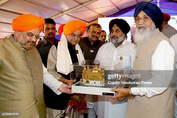 Bharatiya Janata Party National President Amit Shah, Union Finance Minister Arun Jaitley, Deputy CM of Punjab Sukhbir Singh Badal, being honoured by...