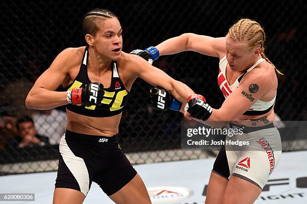 Amanda Nunes of Brazil punches Valentina Schevchenko in their women's bantamweight bout during the UFC 196 event inside the MGM Grand Garden Arena on...