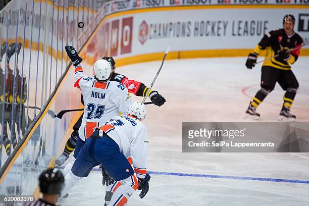 Mikael Kuronen of Lappeenranta challenges Philip Holm of Vaxjo during the Champions Hockey League Round of 16 match between SaiPa Lappeenranta and...