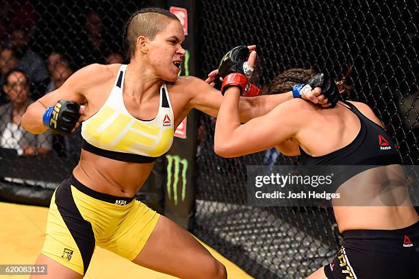 Amanda Nunes of Brazil punches Miesha Tate in their UFC women's bantamweight championship bout during the UFC 200 event at T-Mobile Arena on July 9,...