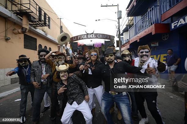 Revellers disguised as drug traffickers take part in the traditional "Convite de fieros" festival, as part of All Saints Day celebrations in Villa...
