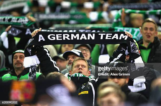 Borussia Moenchengladbach fan holds up a scarf reading 'A German team' prior to kick off during the UEFA Champions League Group C match between VfL...