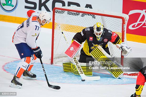 Jussi MArkkanen of Lappeenranta saves Pontus Netterberg of Vaxjo during the Champions Hockey League Round of 16 match between SaiPa Lappeenranta and...