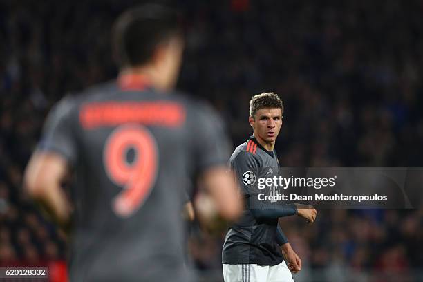 Thomas Mueller of Bayern Muenchen looks at team mate Robert Lewandowski during the UEFA Champions League Group D match between PSV Eindhoven and FC...