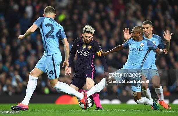 Lionel Messi of Barcelona is tackled by Fernandinho of Manchester City during the UEFA Champions League Group C match between Manchester City FC and...