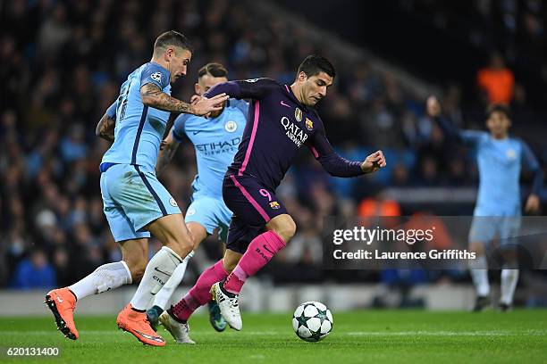 Aleksander Kolorov of Manchester City puts pressure on Luis Suarez of Barcelona during the UEFA Champions League Group C match between Manchester...