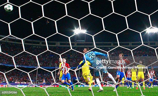 Antoine Griezmann of Atletico Madrid scores his sides second goal by chipping the ball over Soslan Dzhanayev of FC Rostov during the UEFA Champions...