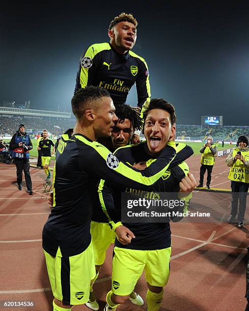 Mesut Ozil celebrates scoring the 3rd Arsenal goal with Kieran Gibbs, Mohamed Elneny and Alex Oxlade-Chamberlin during the UEFA Champions League...