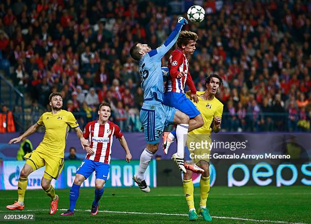 Soslan Dzhanayev of FC Rostov punches the ball while Antoine Griezmann of Atletico Madrid attempts to head the ball during the UEFA Champions League...