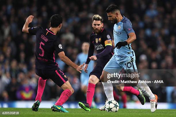 Sergio Aguero of Manchester City competes with Sergio Busquets of Barcelona during the UEFA Champions League match between Manchester City FC and FC...