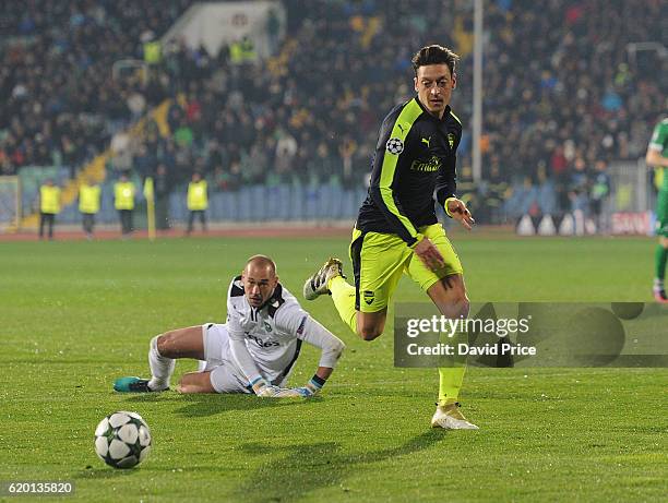 Mesut Ozil of Arsenal knocks the ball past Milan Borjan of Ludogorets during the UEFA Champions League match between PFC Ludogorets Razgrad and...