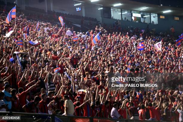 Supporters of Paraguay's Cerro Porteno cheer for their team before the start of the Copa Sudamericana semifinal football match against Colombia's...