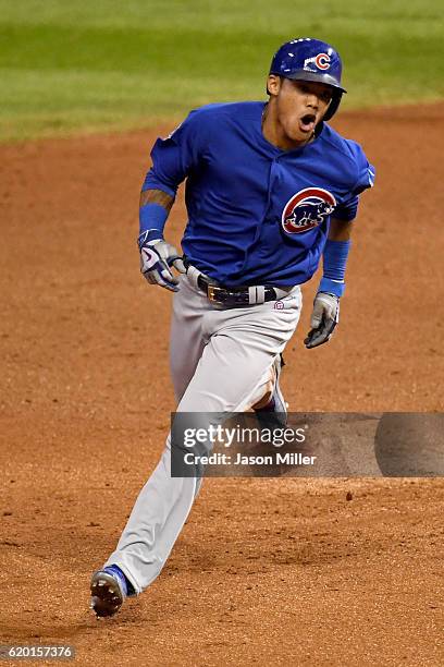 Addison Russell of the Chicago Cubs celebrates as he runs the bases after hitting a grand slam home run during the third inning against the Cleveland...