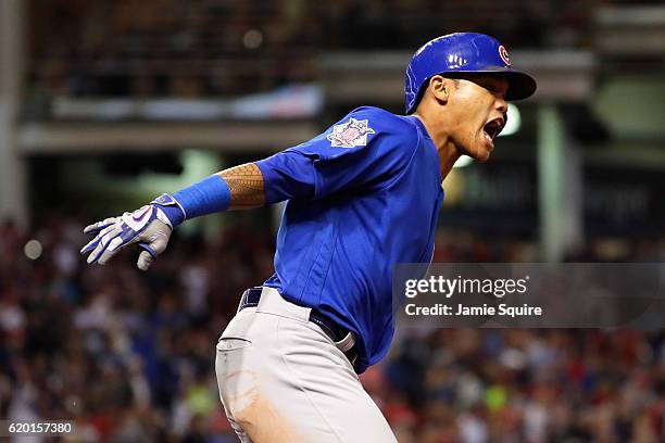 Addison Russell of the Chicago Cubs celebrates as he runs the bases after hitting a grand slam home run during the third inning against the Cleveland...