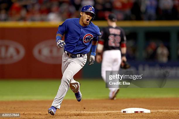 Addison Russell of the Chicago Cubs celebrates as he runs the bases after hitting a grand slam home run during the third inning against the Cleveland...