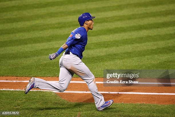 Addison Russell of the Chicago Cubs celebrates as he runs the bases after hitting a grand slam home run during the third inning against the Cleveland...