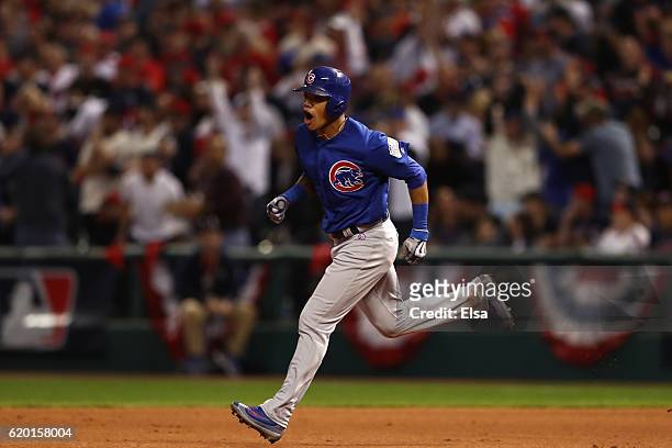 Addison Russell of the Chicago Cubs celebrates as he runs the bases after hitting a grand slam home run during the third inning against the Cleveland...