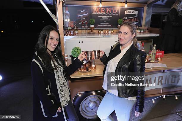 Guests pose in front of the Smirnoff Copper Truck with their complimentary Smirnoff Moscow Mule Mugs during the 2016 New York Taste presented by Citi...