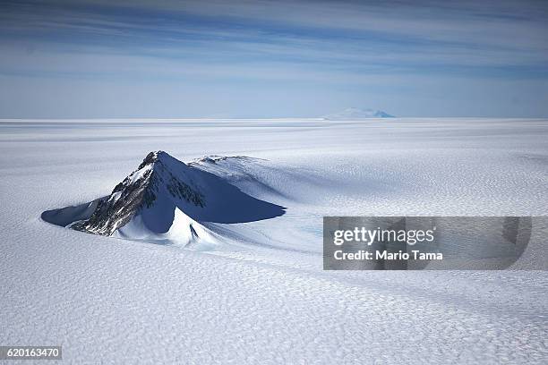 Section of the West Antarctic Ice Sheet with mountains is viewed from a window of a NASA Operation IceBridge airplane on October 28, 2016 in-flight...