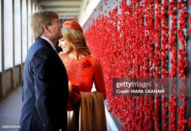 Dutch King Willem-Alexander and Queen Maxima stop to place poppies on the wall of rememberence during a visit to the Australian War Memorial in...