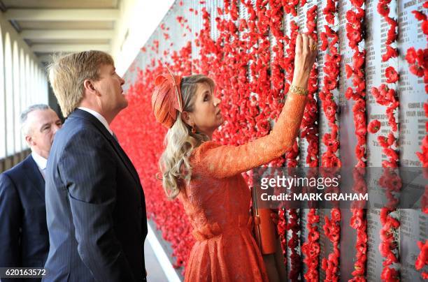 Dutch King Willem-Alexander and Queen Maxima place poppies on the wall of rememberence during a visit to the Australian War Memorial in Canberra on...