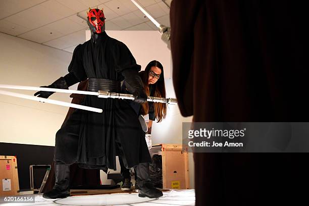 Joanee Honour, senior registrar at the Lucas Museum of Narrative Art fluffing the costume of Sith Lord Darth Maul in the Star Wars and the Power of...