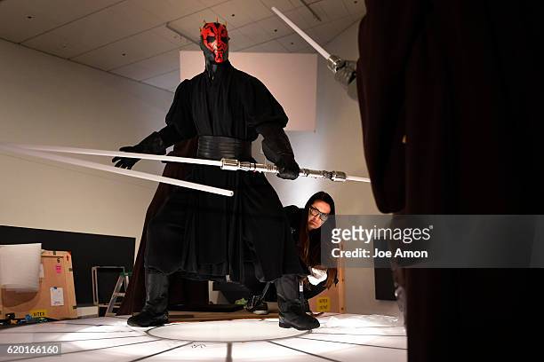 Joanee Honour, senior registrar at the Lucas Museum of Narrative Art fluffing the costume of Sith Lord Darth Maul in the Star Wars and the Power of...